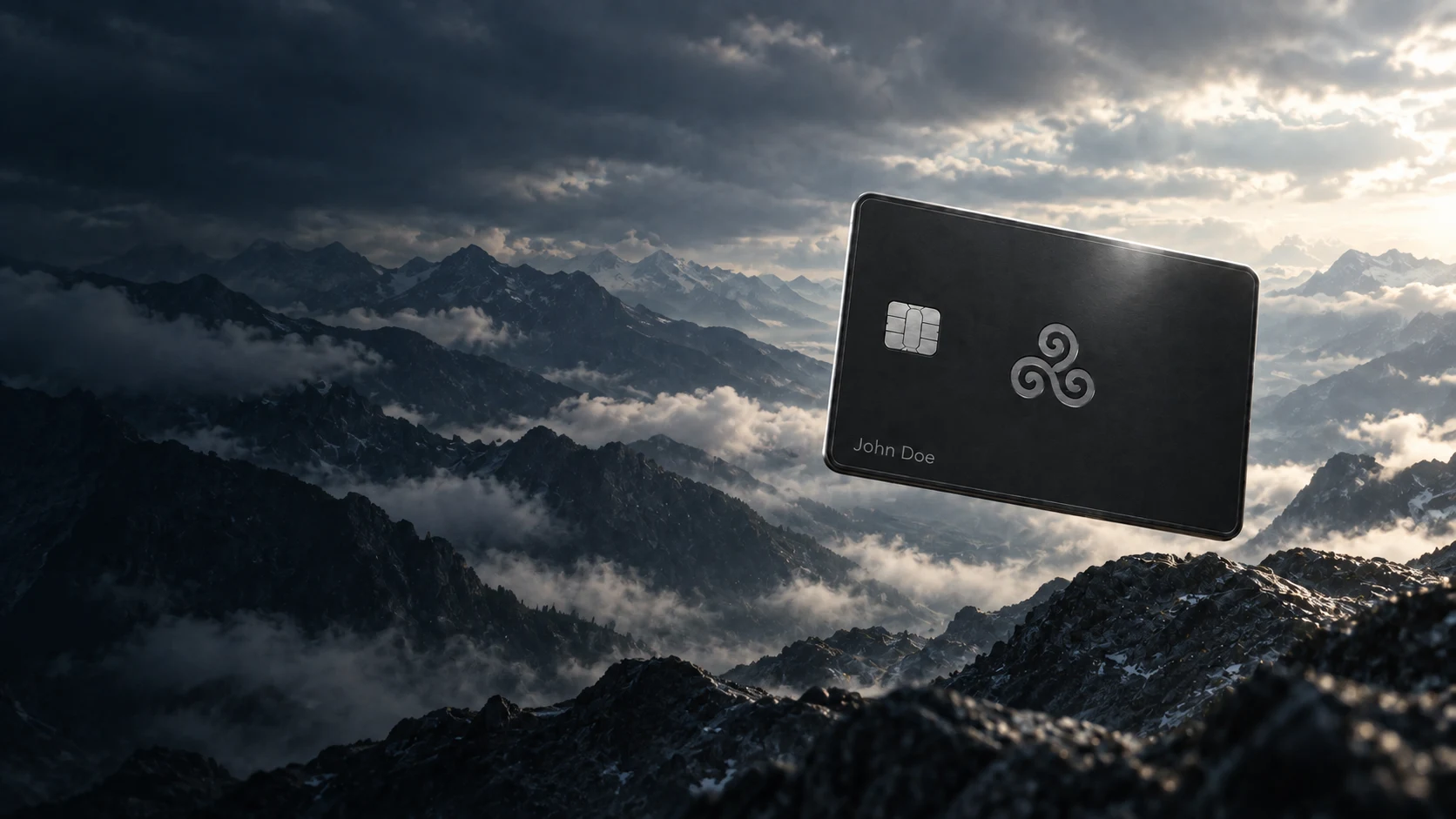 A black titanium Bursa card with an engraved swirl and the name John Doe, floating above slate mountains and silver clouds.